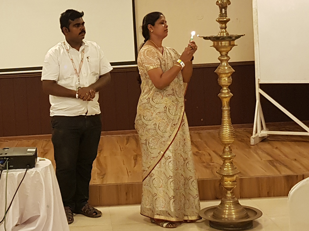 Vinolin, CFO of Techfruits, gracefully lights the ceremonial lamp, symbolizing the illumination of success and prosperity during the Annual Day Celebrations on June 1, 2019.